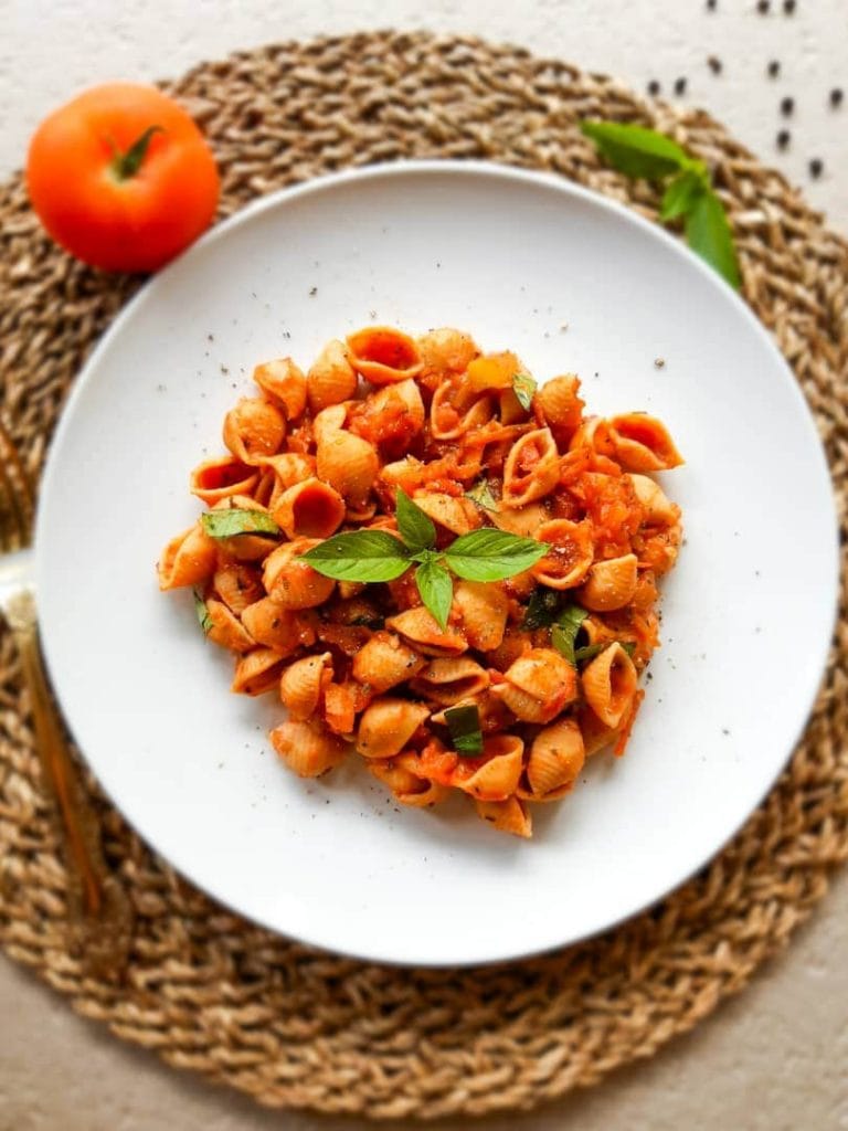 An overhead shot of pasta served on a white plate.