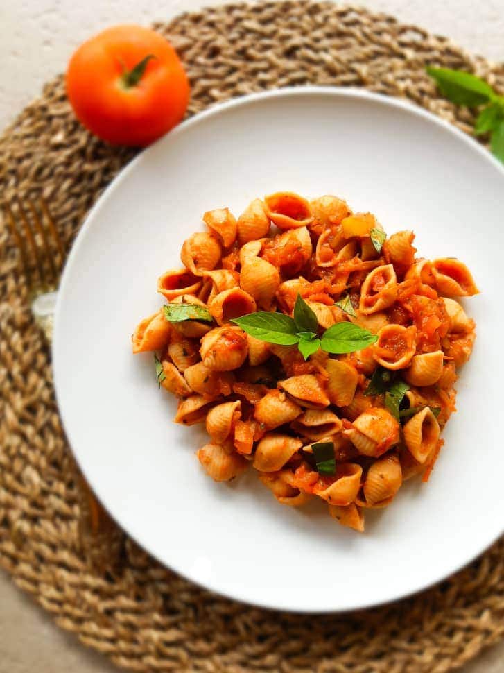 Tomato pasta served on a white plate