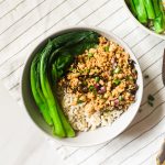 Tofu mince served with some brown rice and choy sum topped with chopped scallions