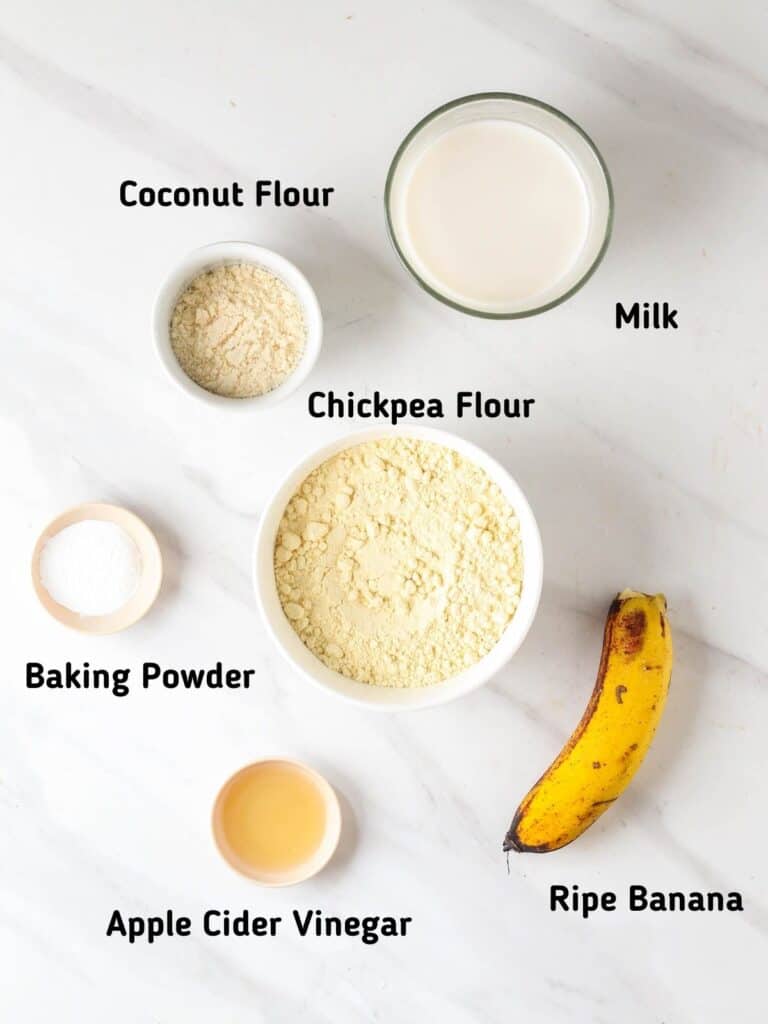 Ingredients needed for this recipe like coconut flour, chickpea flour, milk, baking powder, apple cider vinegar and banana.