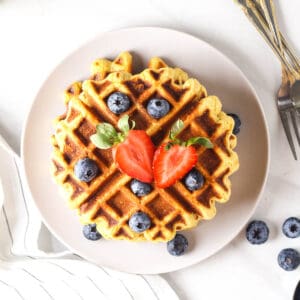 An overhead look of a stack of protein waffles on a purple plate.