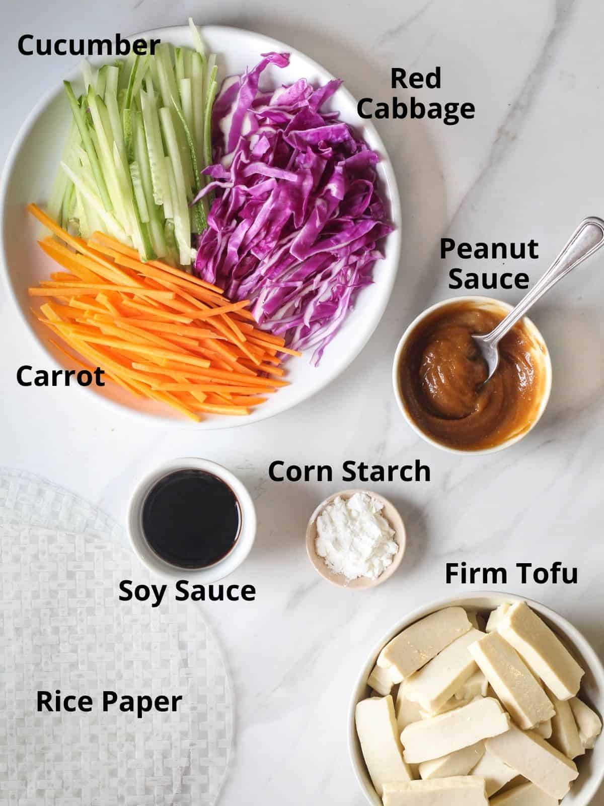 Ingredients needed in this recipe like carrot, cabbage, cucumber, peanut sauce, soy sauce, corn starch and tofu.