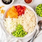 A close up shot of a bowl containing different components of the salad.