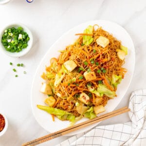 A close up shot of fried been hoon on a white plate.