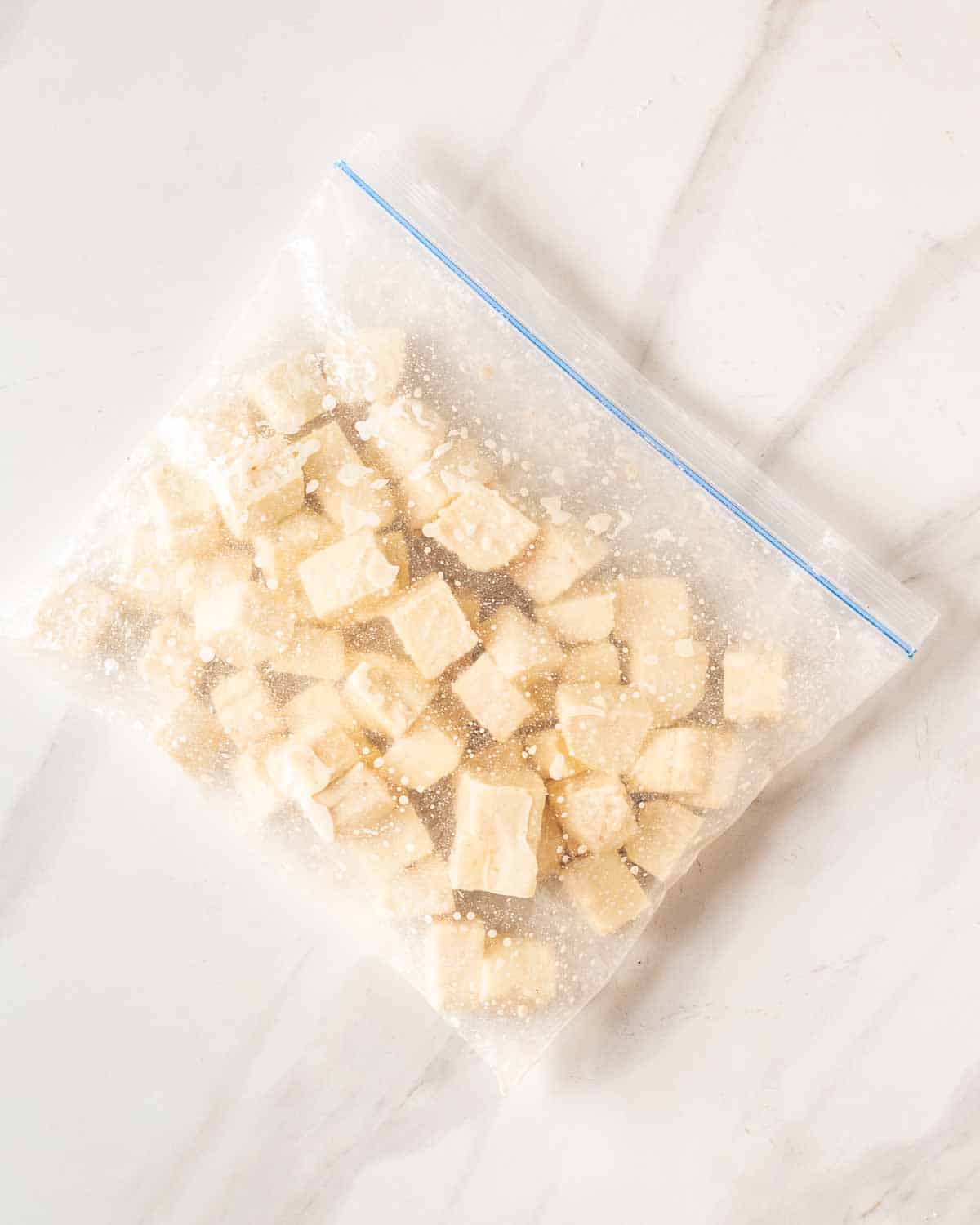 Tofu cubes in a zip top bag.