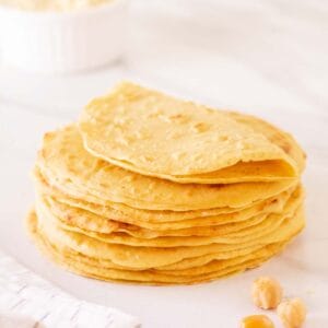 Side shot of a stack of chickpea flour tortillas.