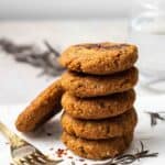 A stack of 5 vegan sausage patties with another one leaning on the stack.