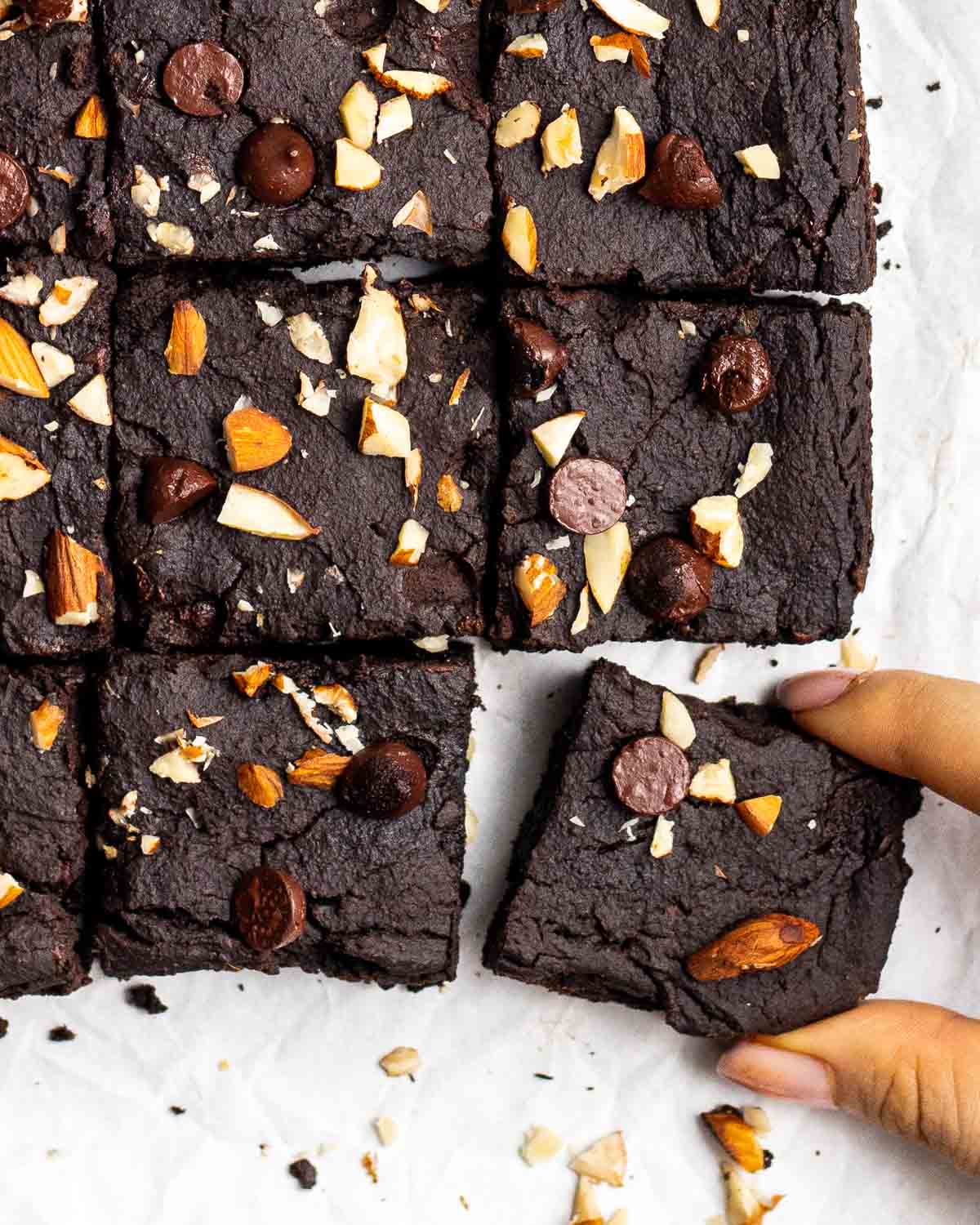 Taking out a slice of brownies from a tray of it.