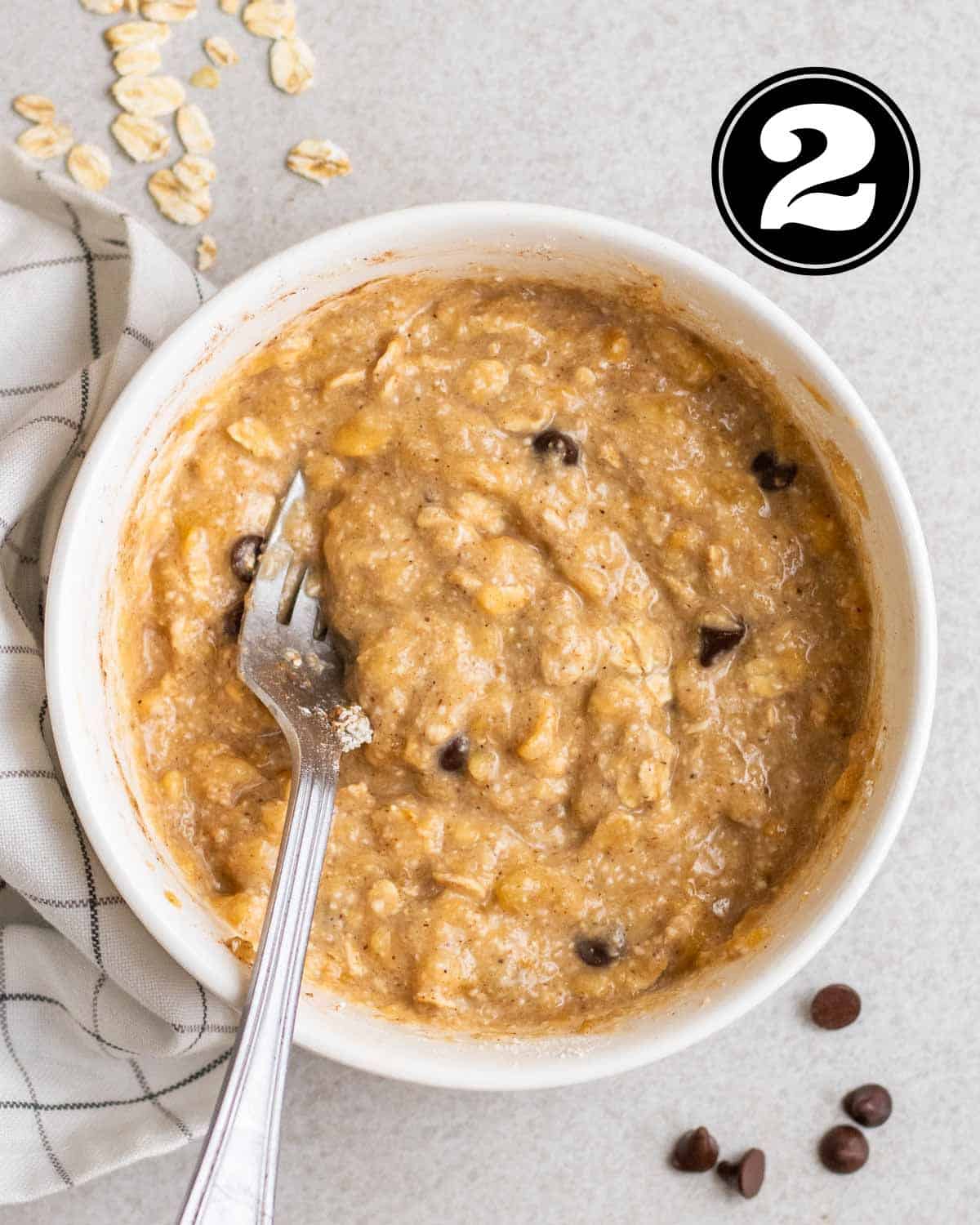 Mug cake batter in a ramekin with a fork beside.