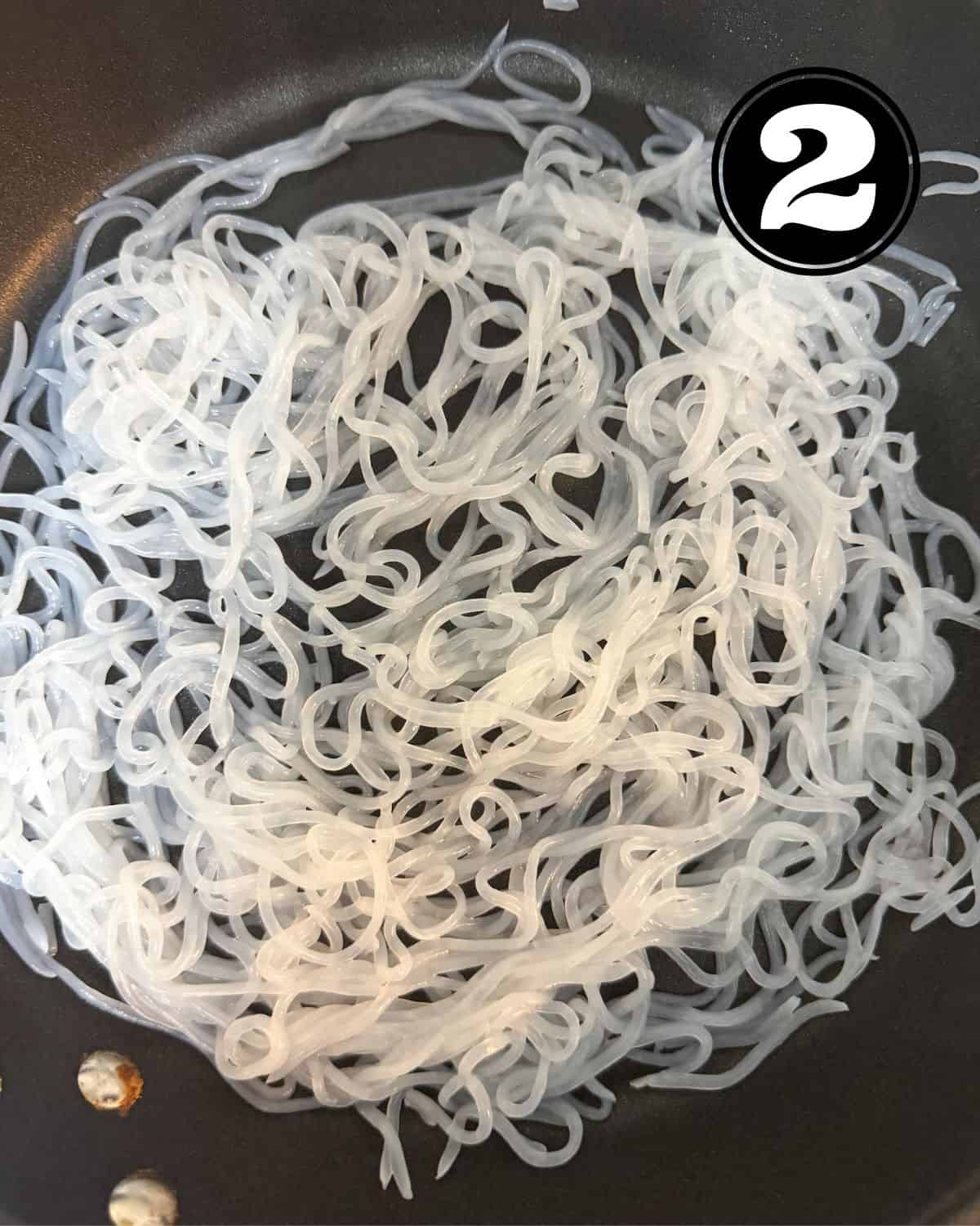 Cooked shirataki noodles in a pan.