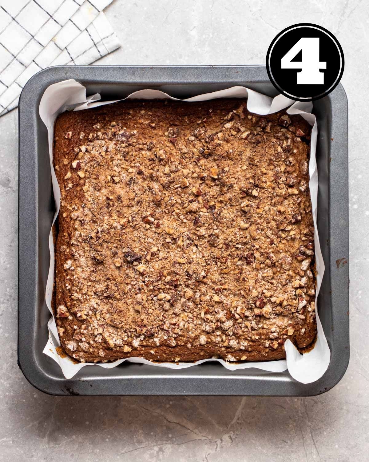 A tray of baked coffee cake in a square baking pan.