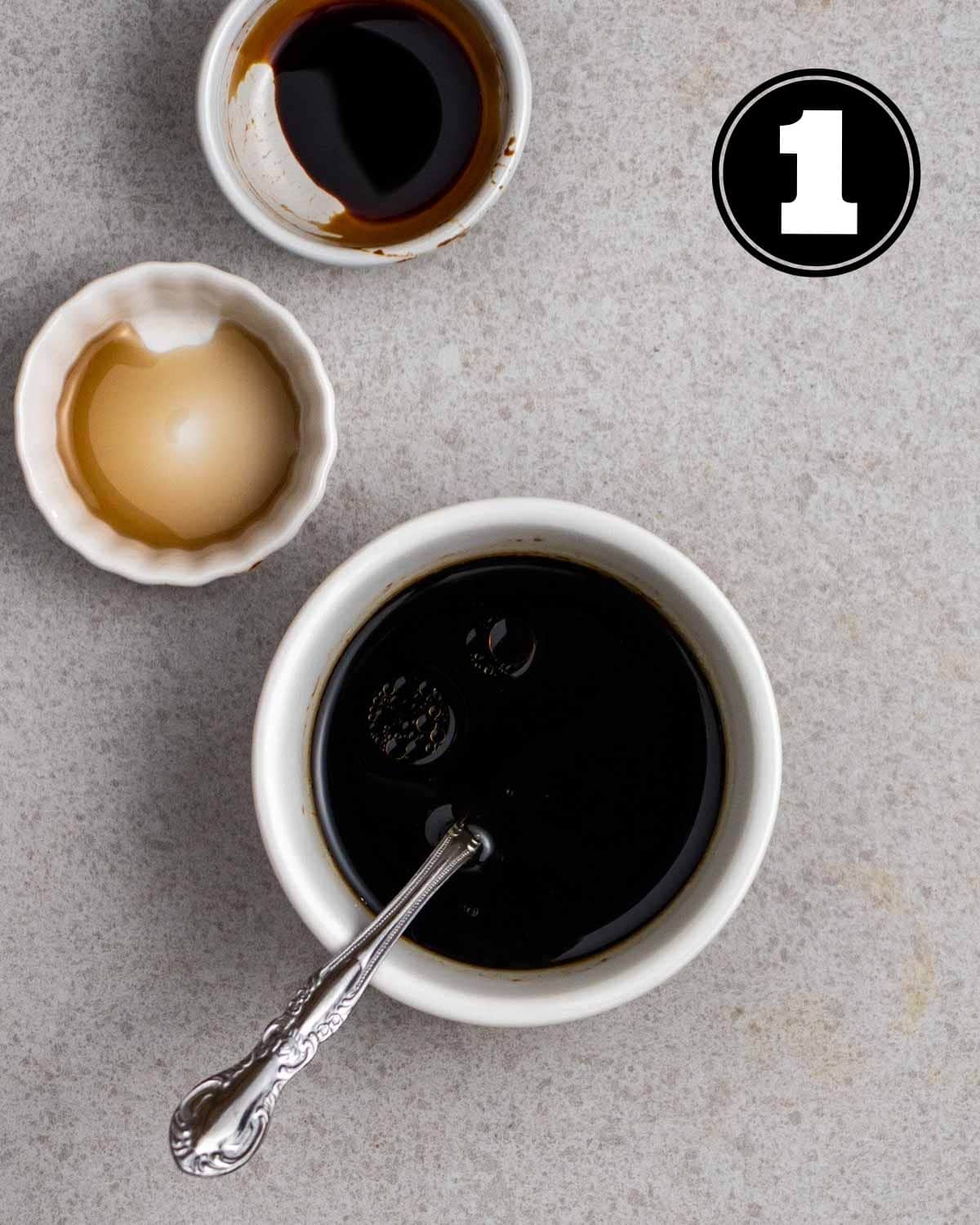 Stir-fry sauce for fried bee hoon in a ramekin with a teaspoon beside.