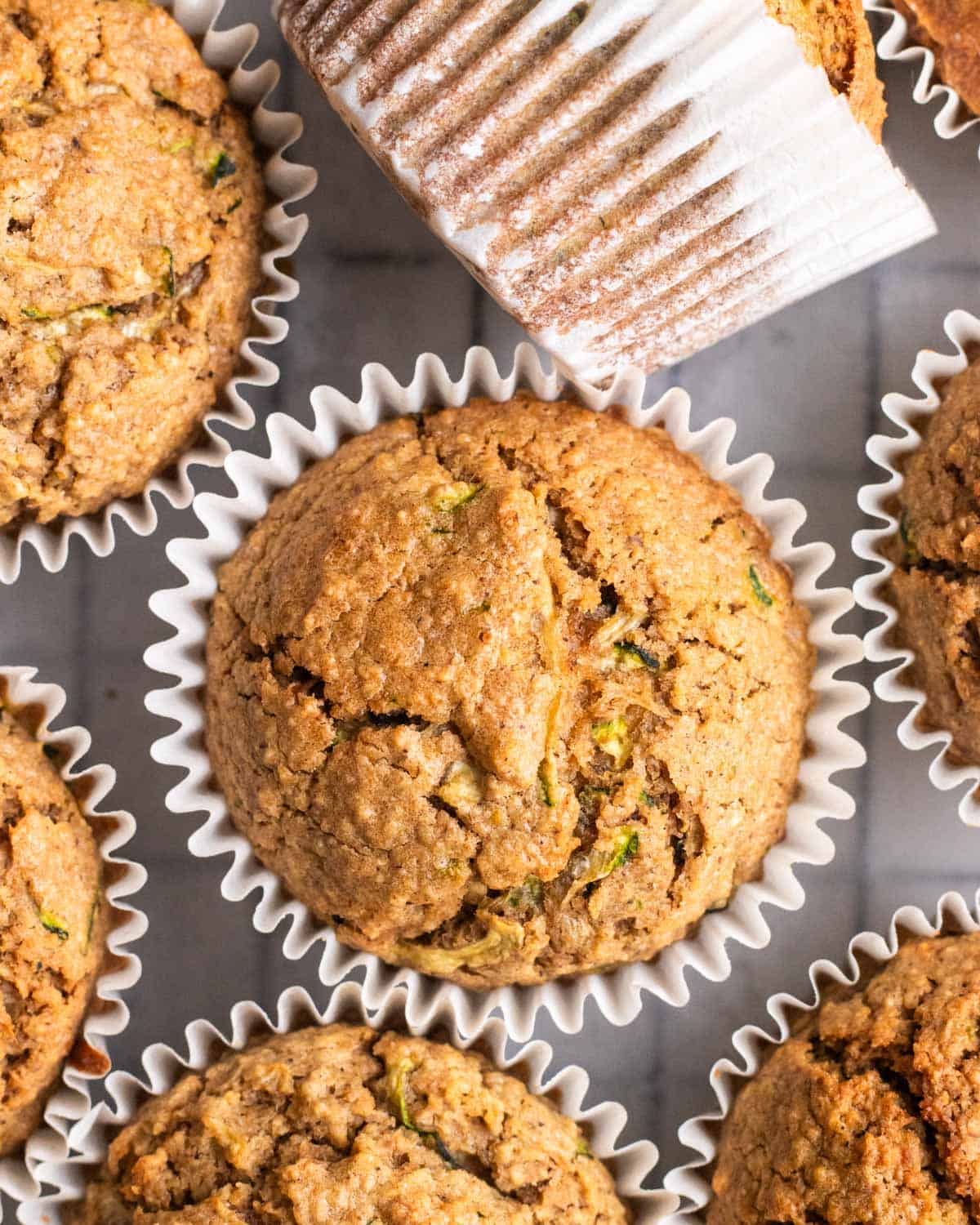 Applesauce zucchini muffins arranged on a tray.