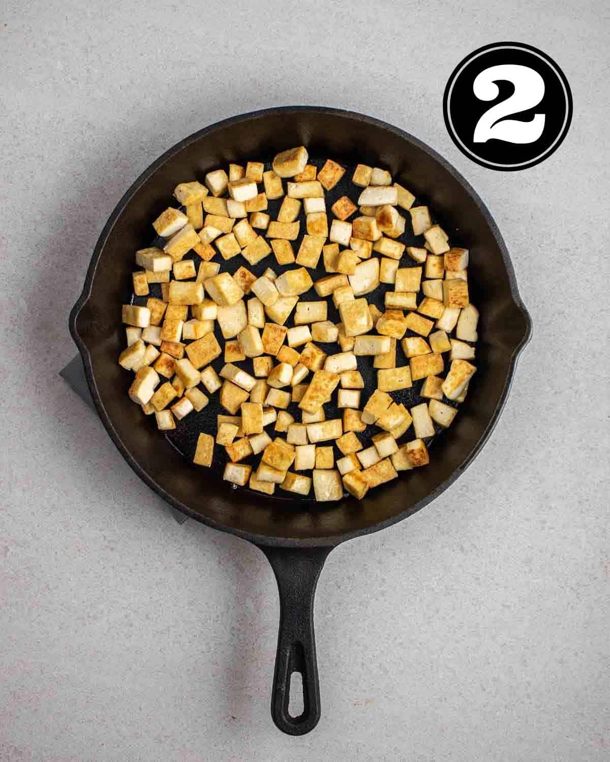 Pan-fry tofu in a cast iron skillet.