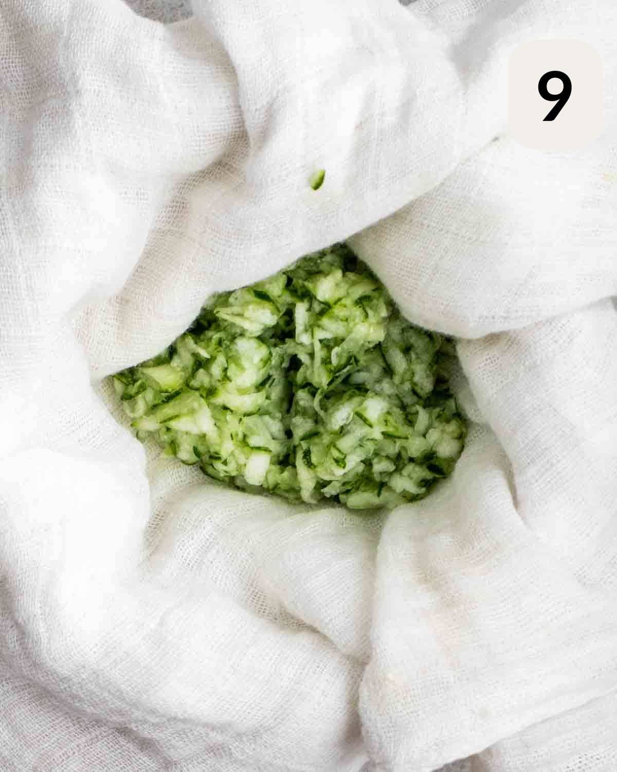 Squeezing shredded cucumber in a cheesecloth.
