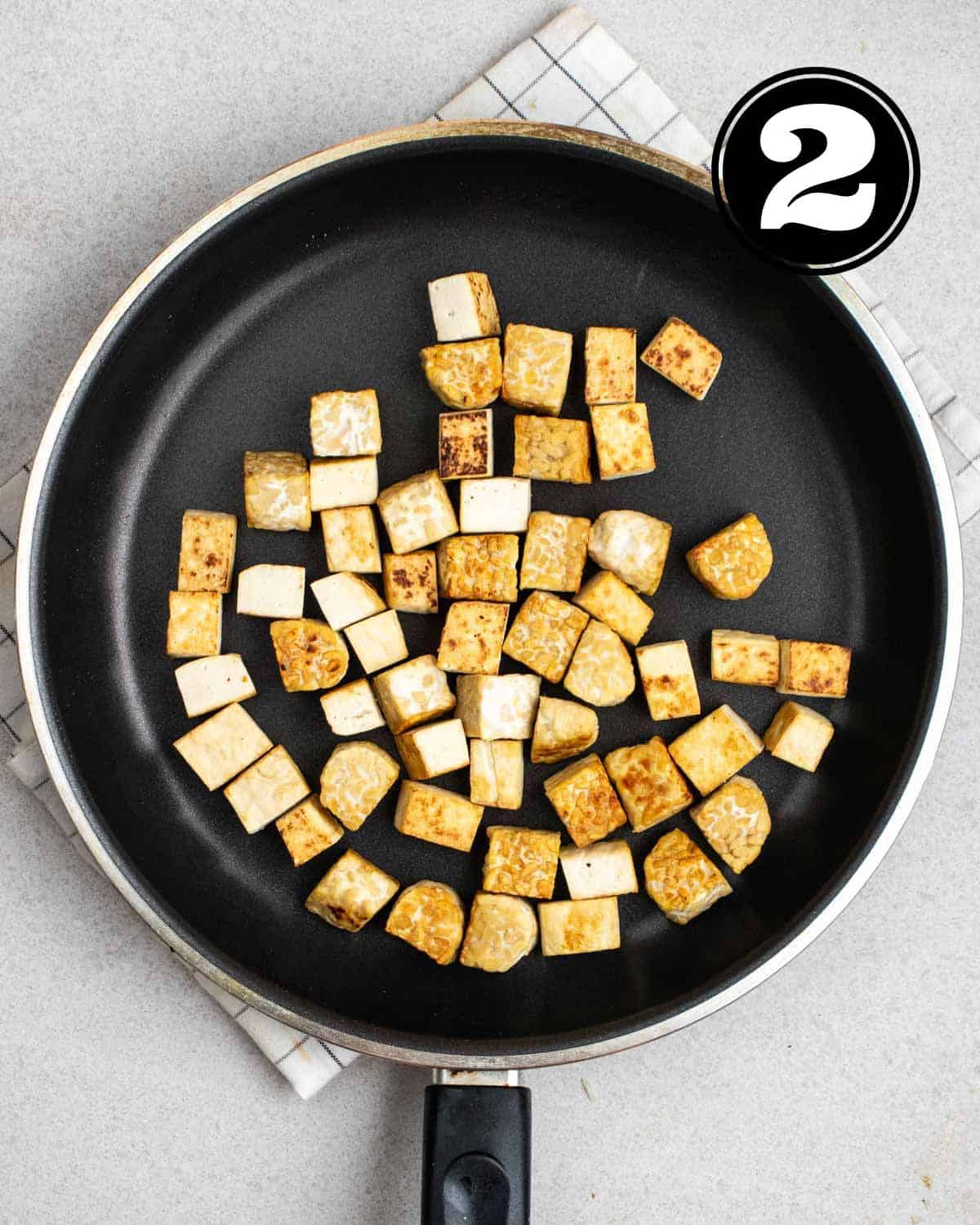Pan-fried tofu and tempeh in a non-stick pan.