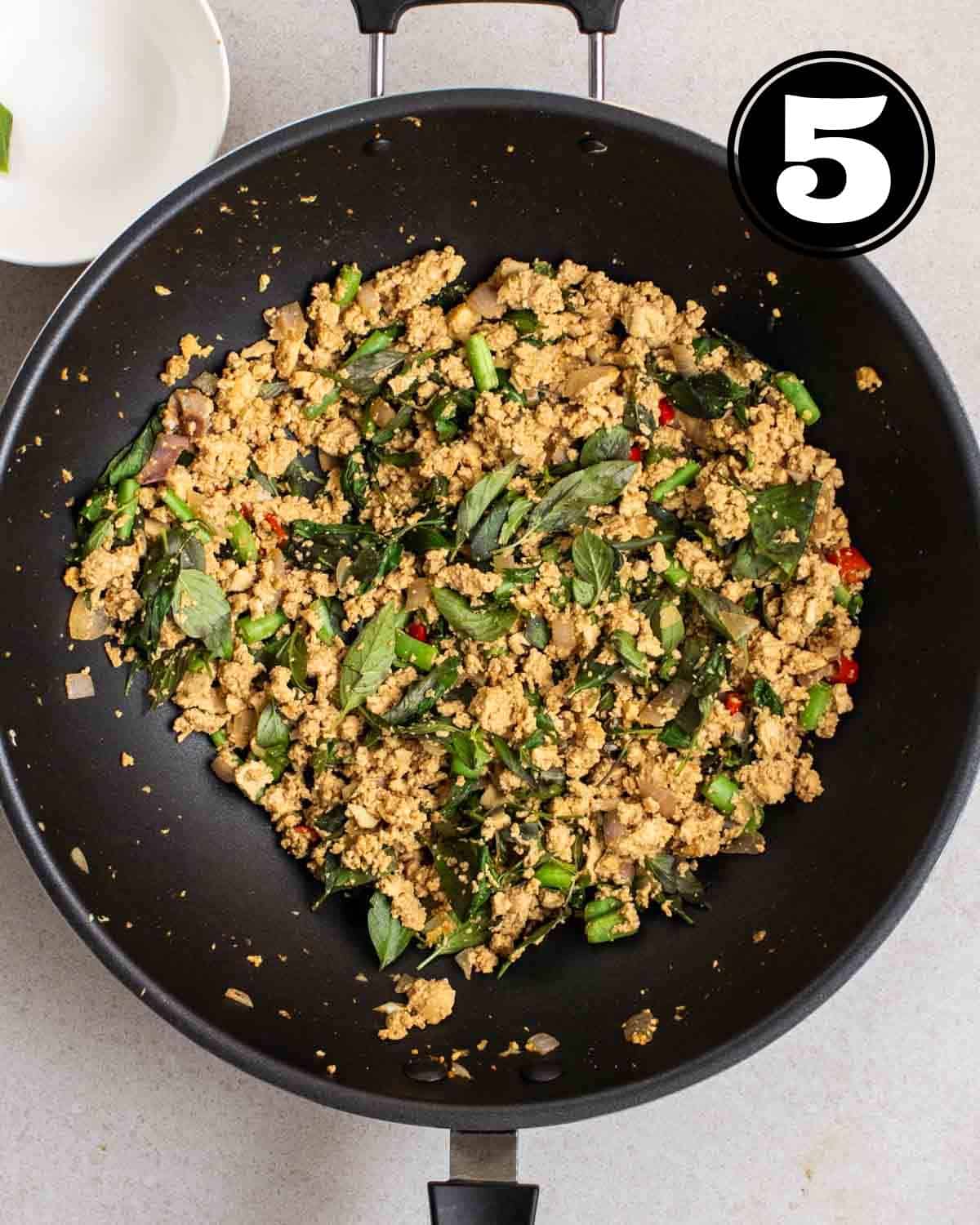 A wok of Thai basil tofu.