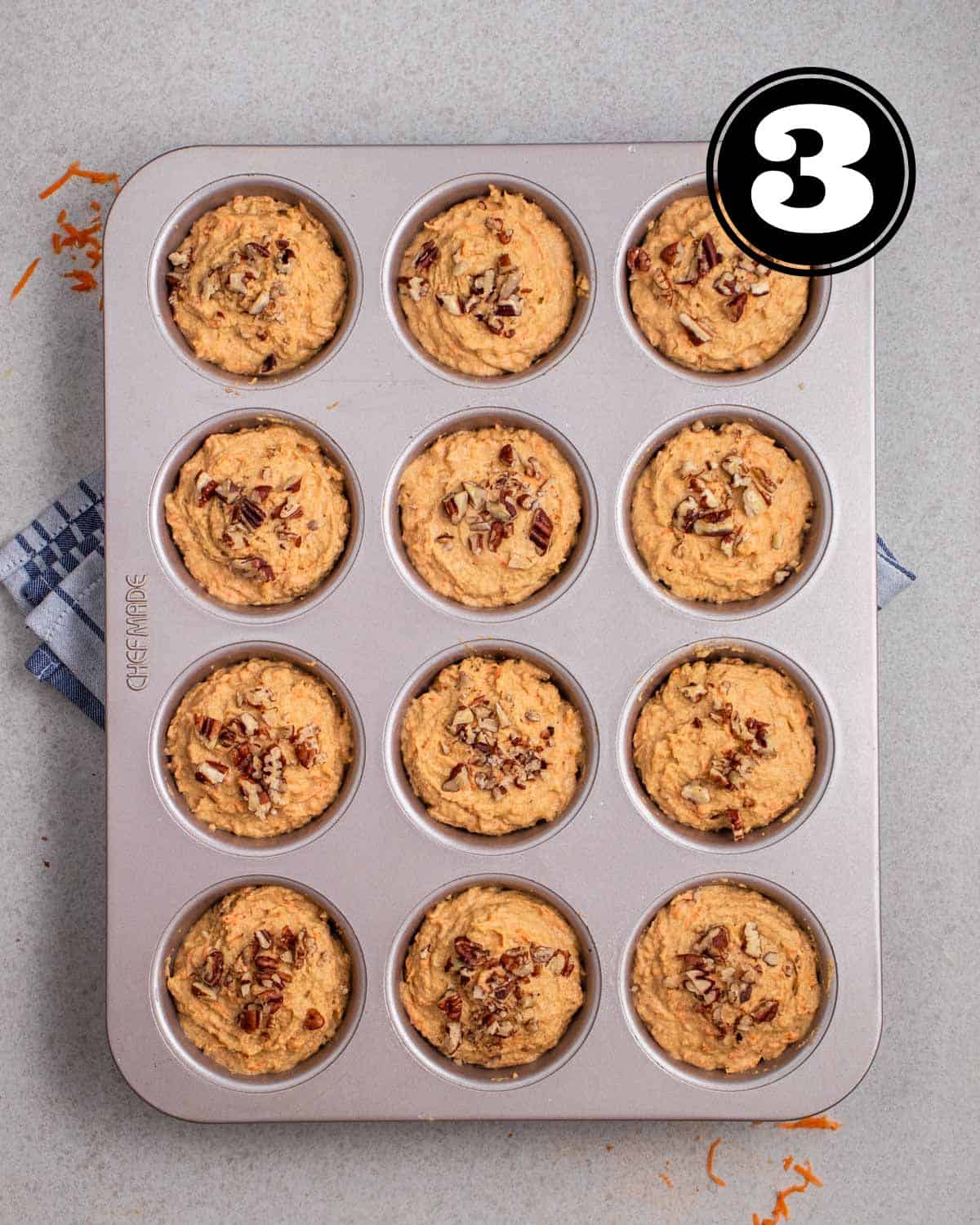 Unbaked muffin batter in a muffin tin.