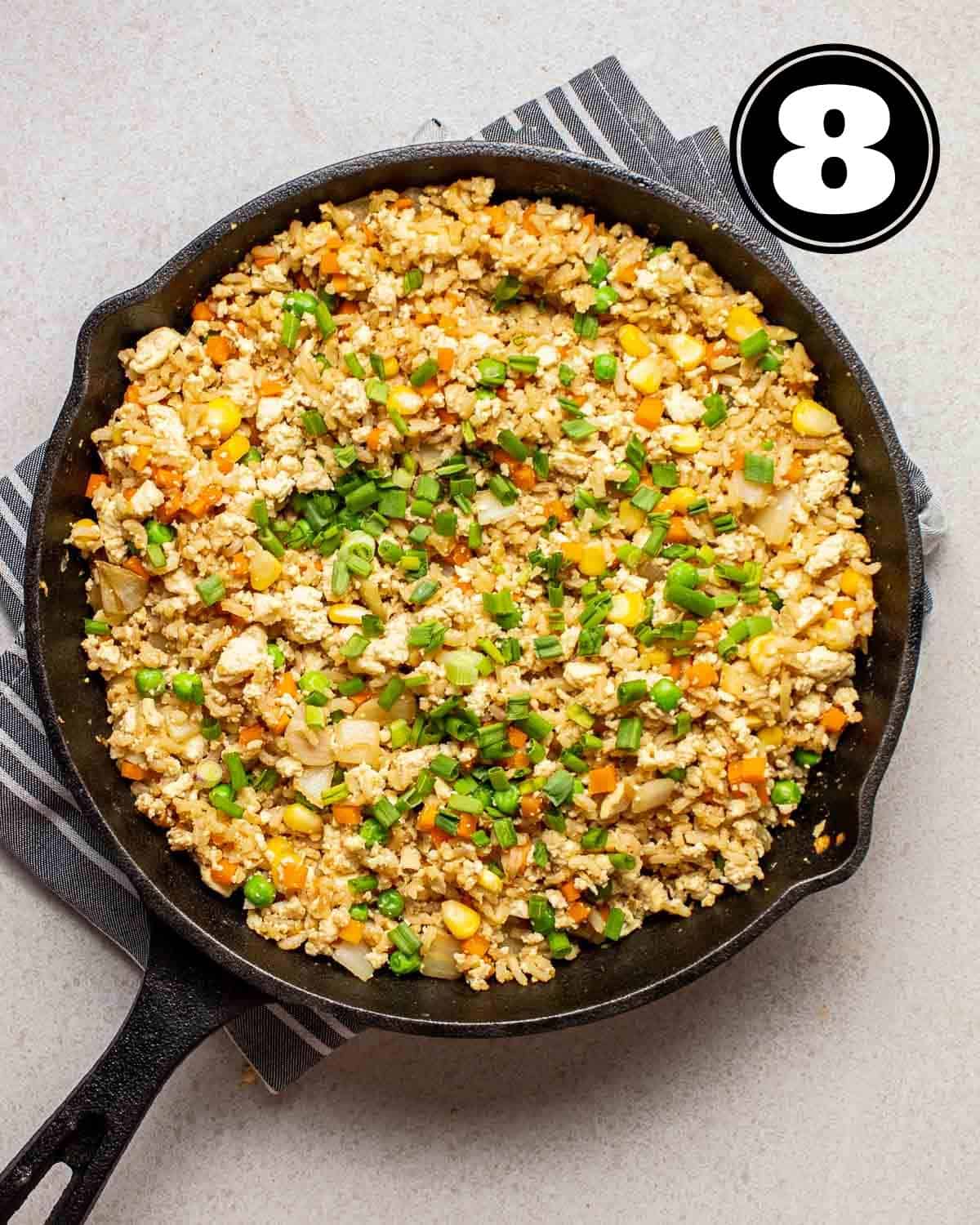 Adding green onion into vegan egg fried rice.