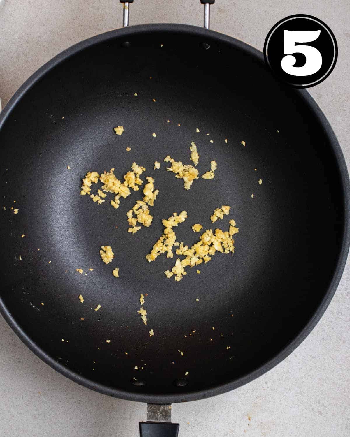 Fried ginger and garlic in a wok.
