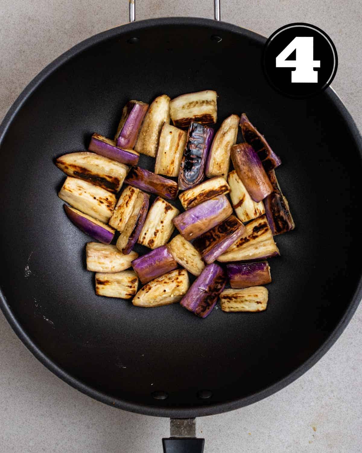 Fried eggplant in a wok.