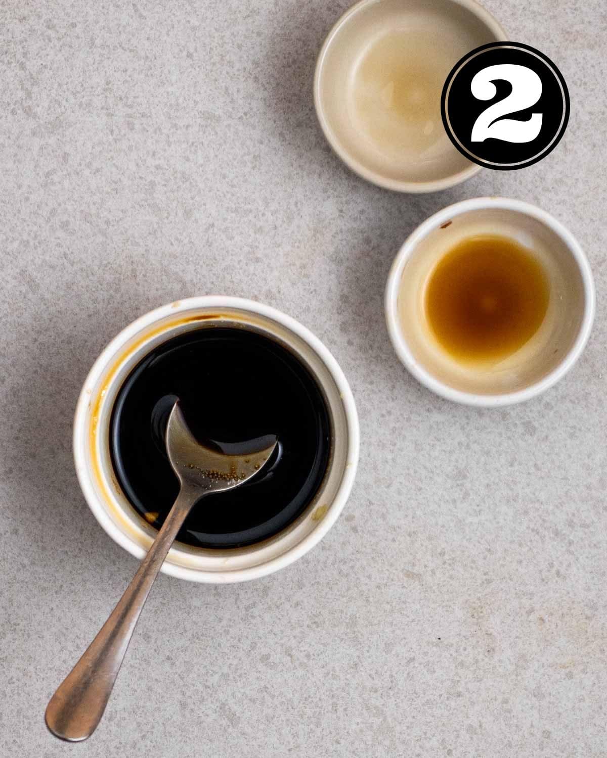 Stir-fry sauce in a ramekin with a teaspoon beside with 2 sauce dishes beside.