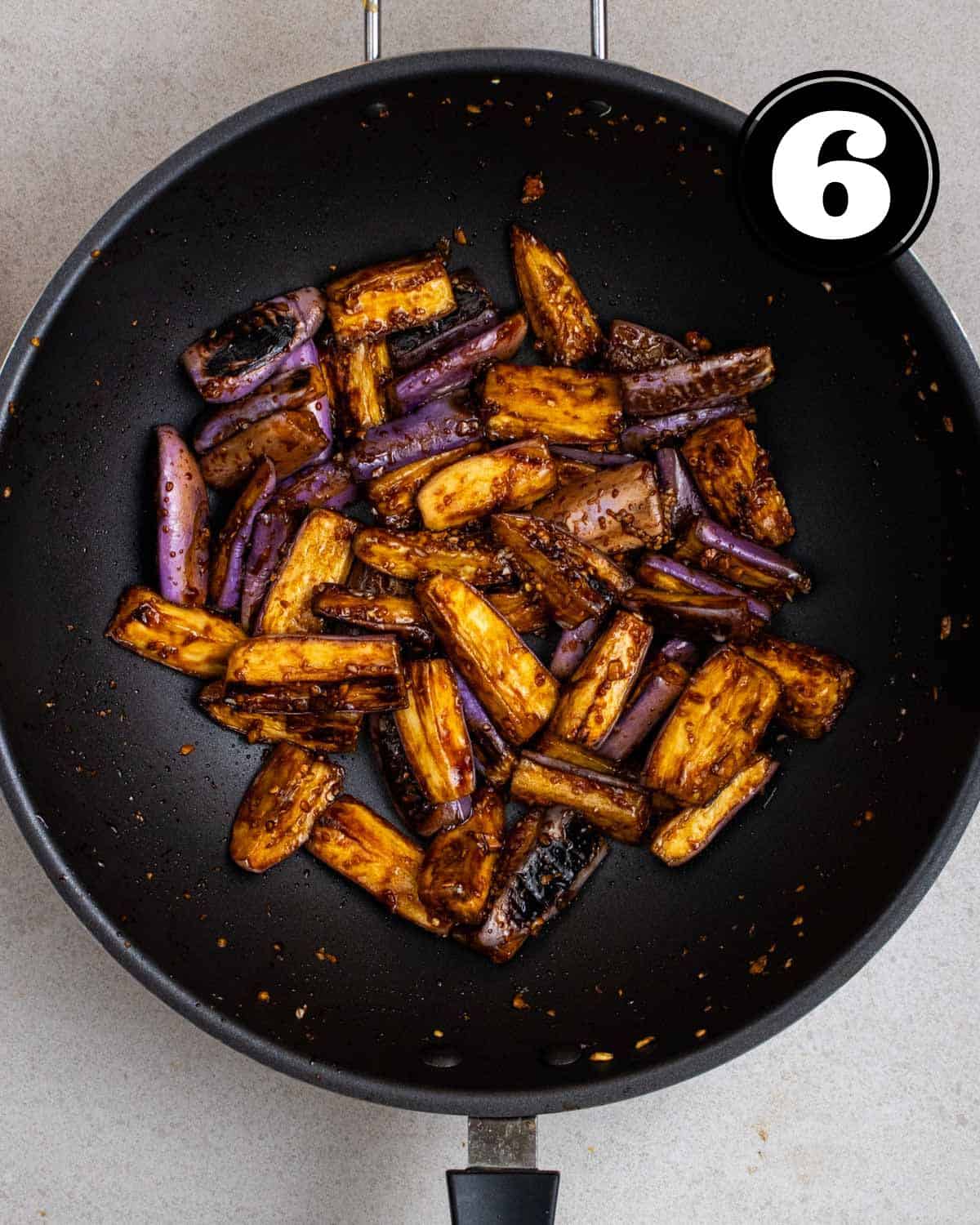 A wok of cooked garlic eggplant.