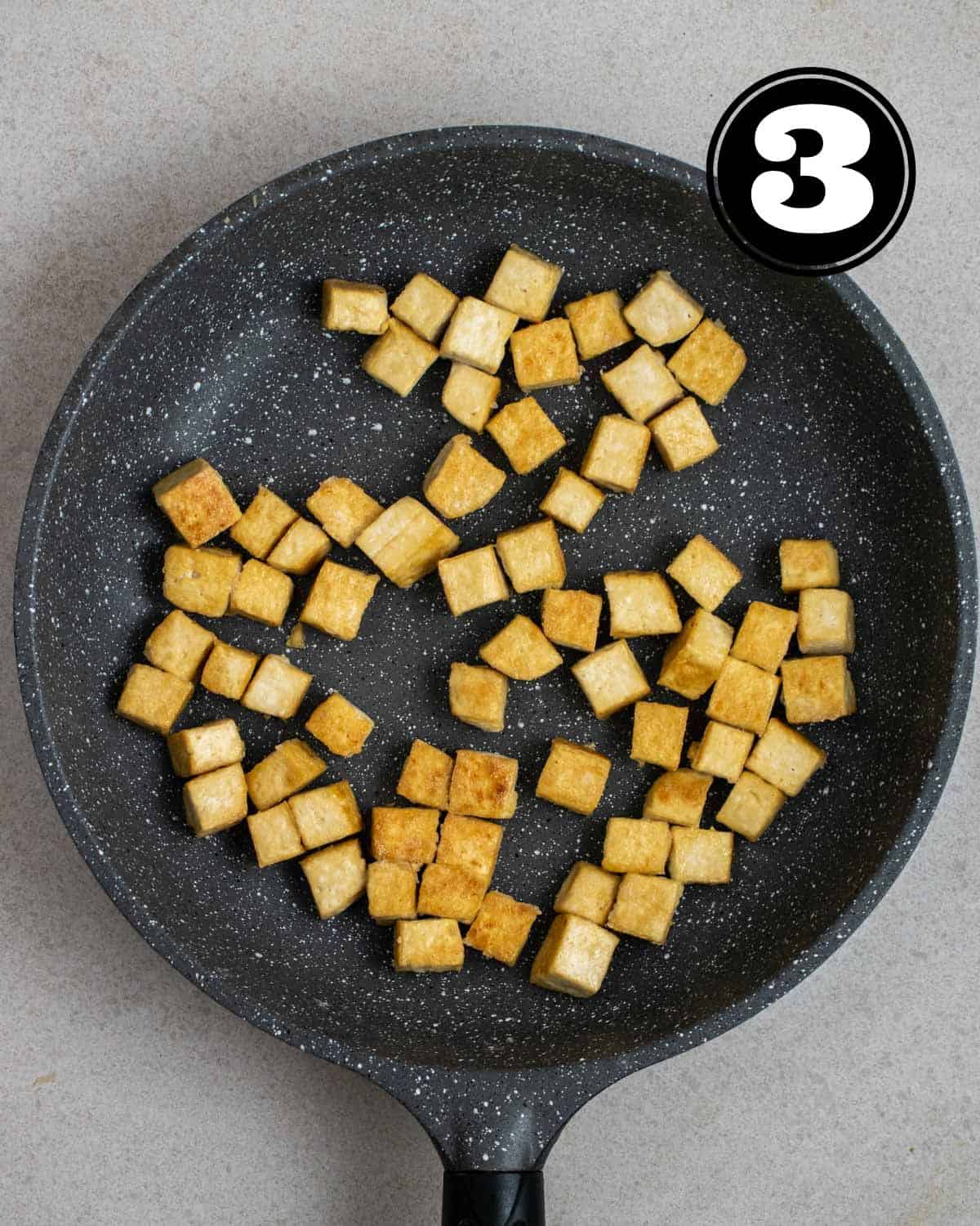 Pan-fried tofu in a non-stick pan.