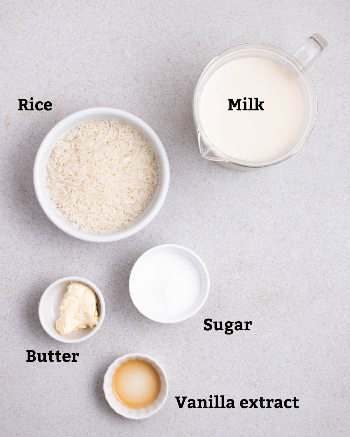 Ingredients needed like rice, milk, sugar, butter, and vanilla extract.