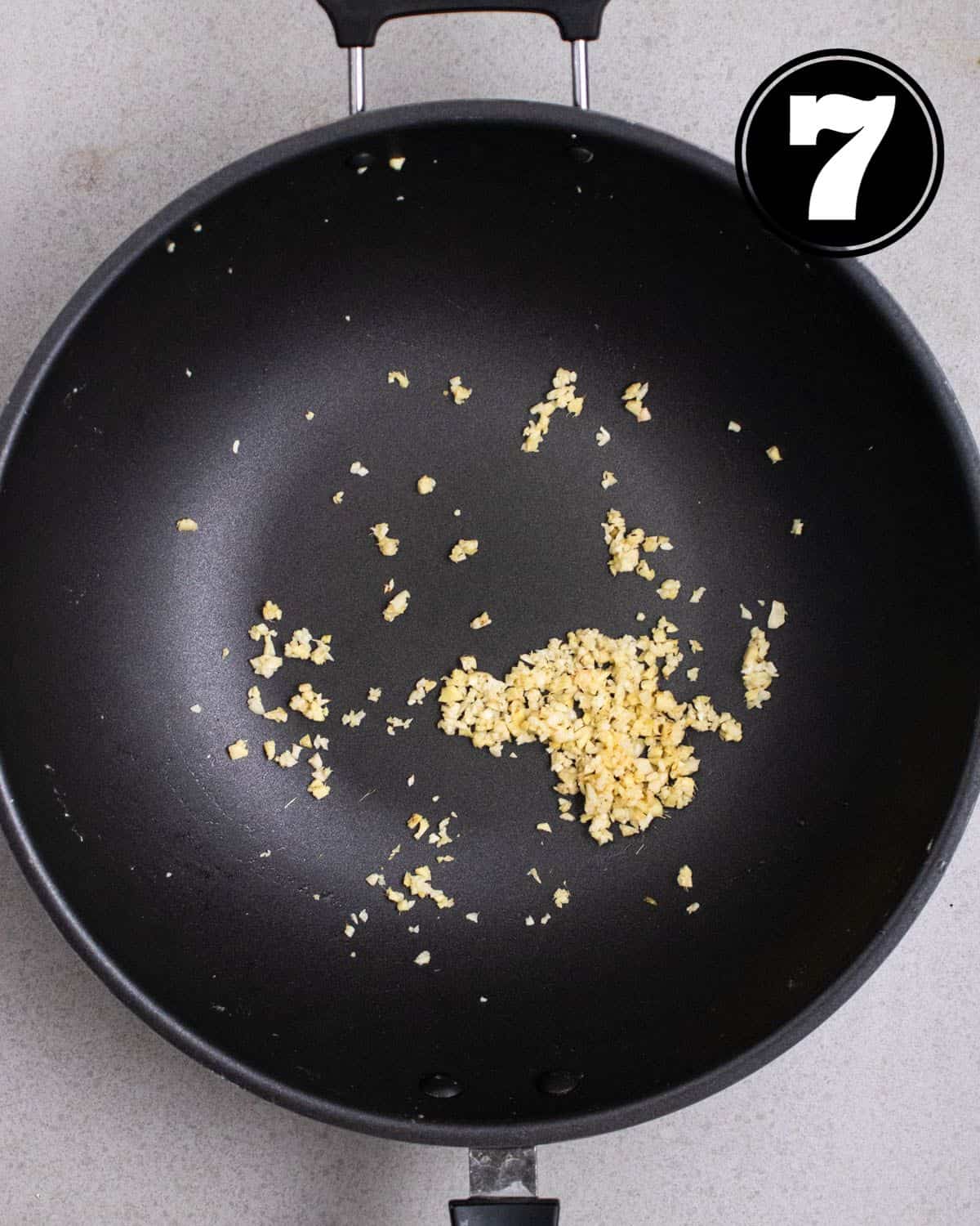 Cooked garlic and ginger in a wok.