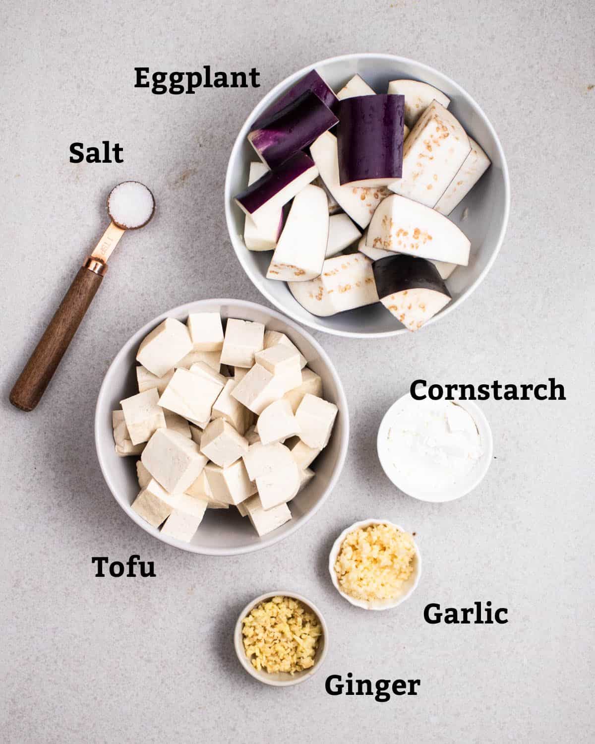 Ingredients needed like eggplant, salt, tofu, cornstarch, garlic, and ginger.
