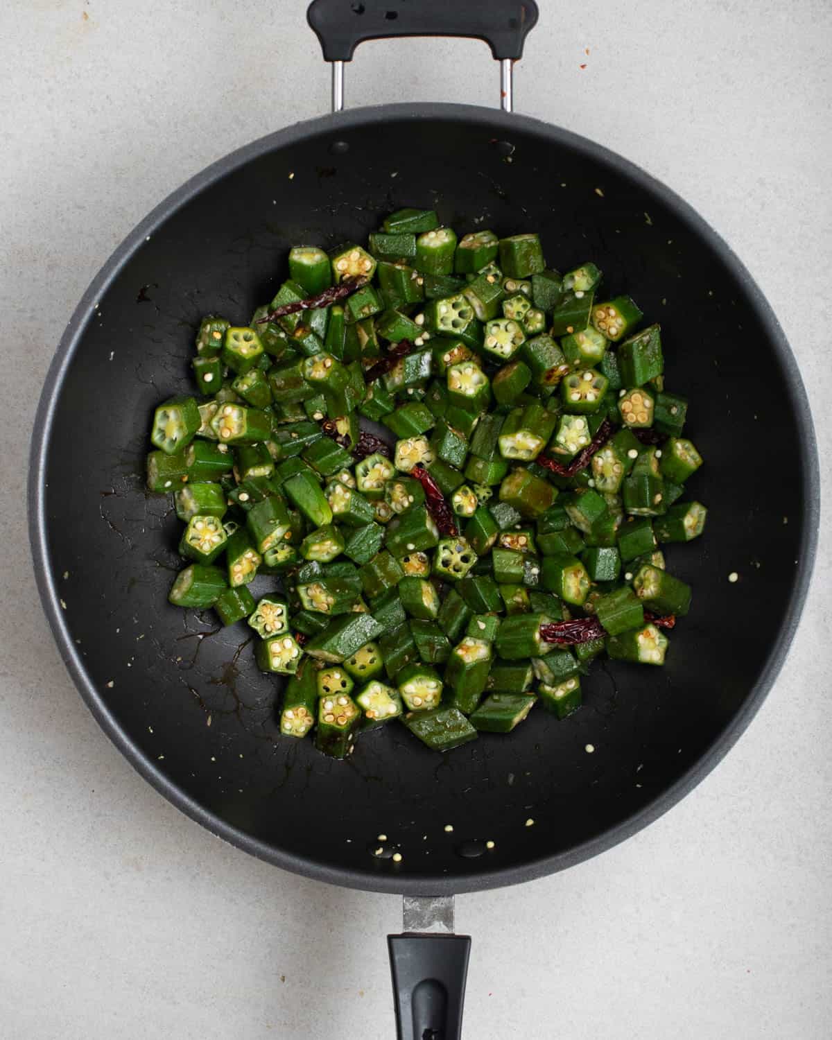Okra stir-fry in a wok.