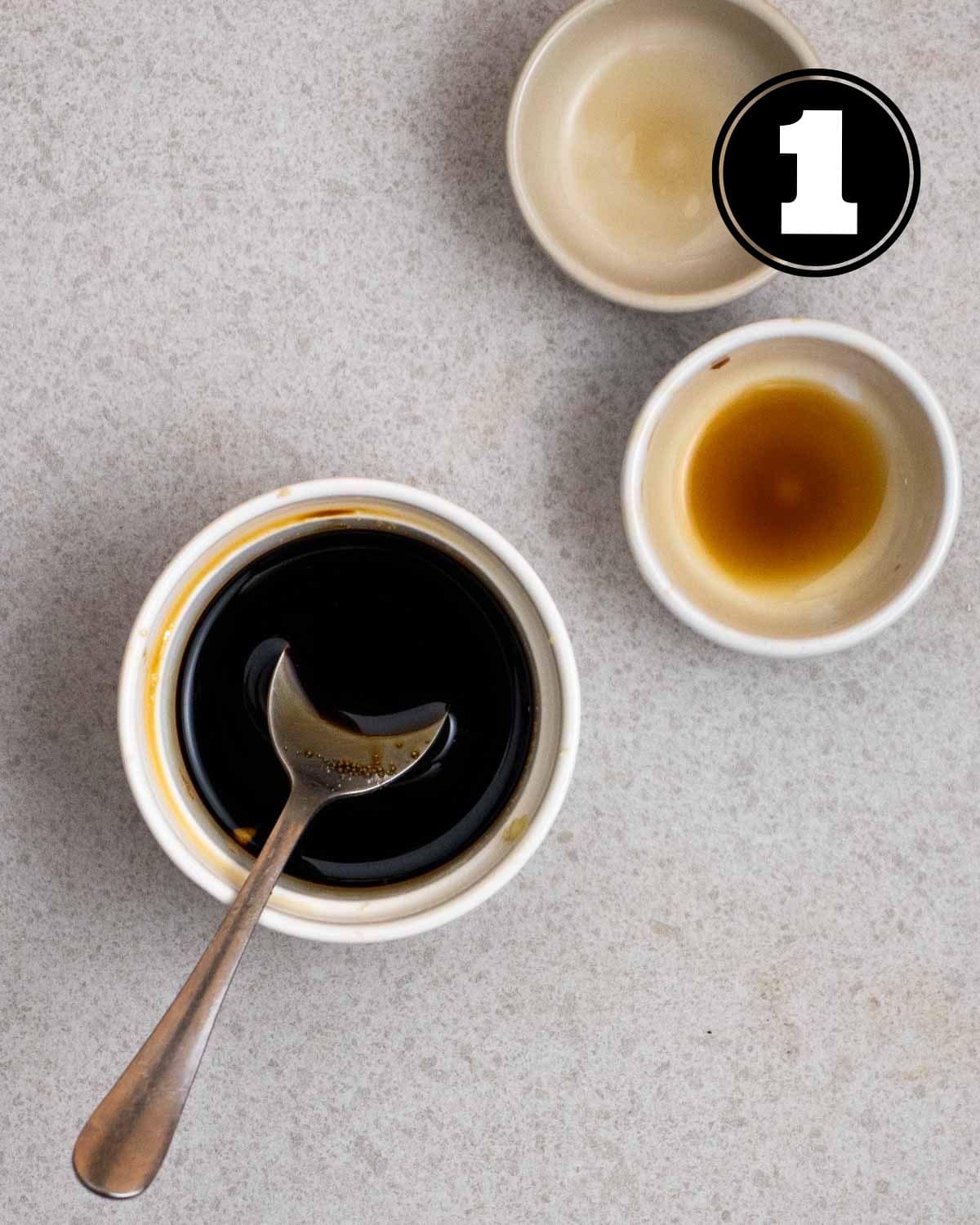 Sauce for Szechuan tofu in a ramekin with a spoon beside with 2 sauce dishes in a background.