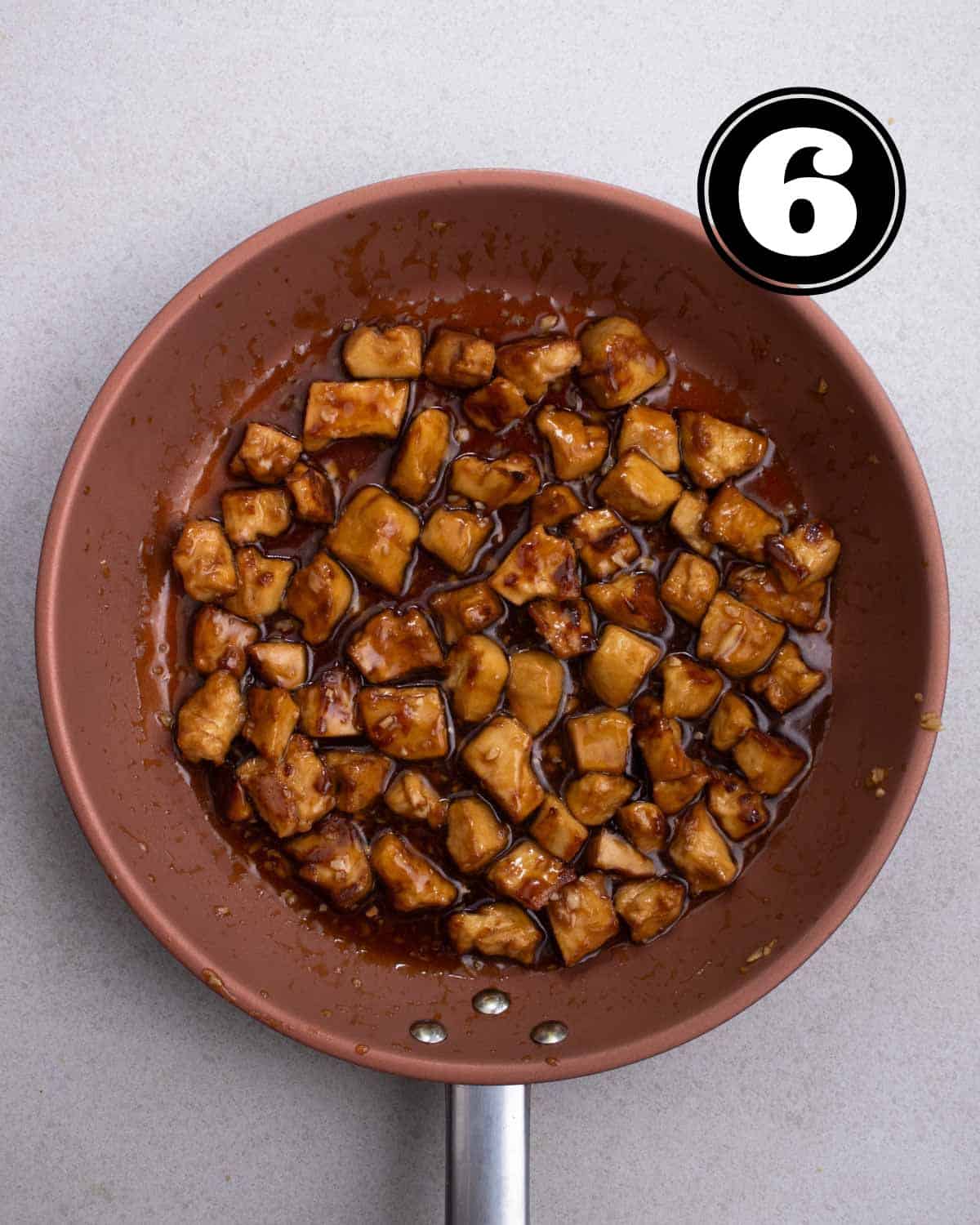 Teriyaki tofu in a non-stick pan.