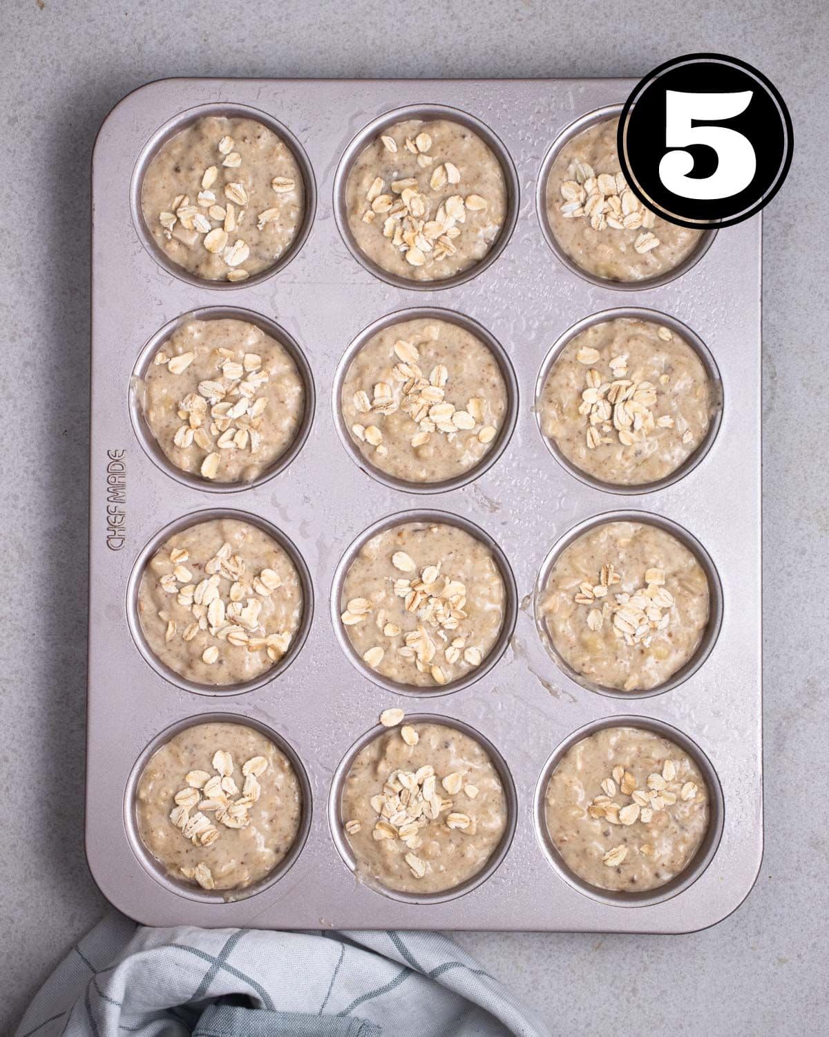 Unbaked muffins in a muffin tray.