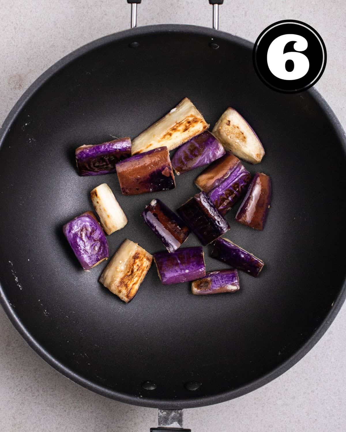 Pan-fried eggplant ina wok.