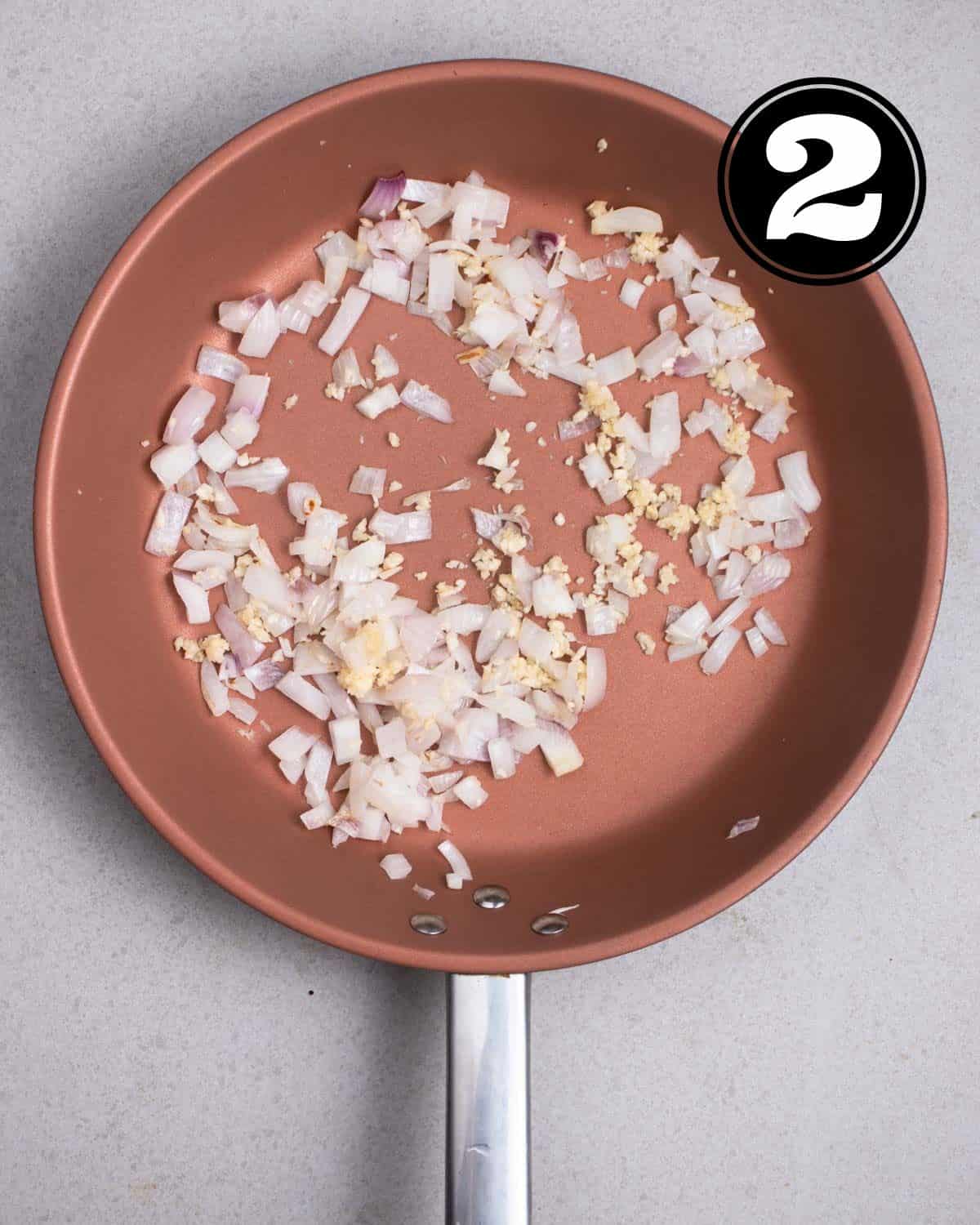 Cooked onion and garlic in a non-stick pan.