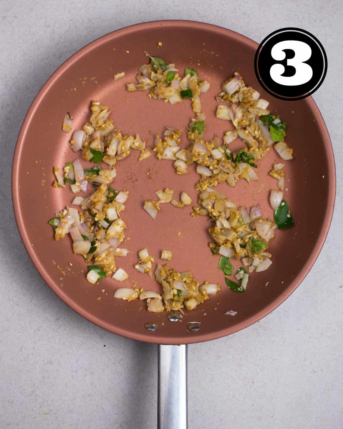 Frying curry paste, onion, kaffir lime leaves, and garlic in a pan.