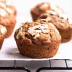 Banana muffins arranged on a baking tray lined with parchment paper.