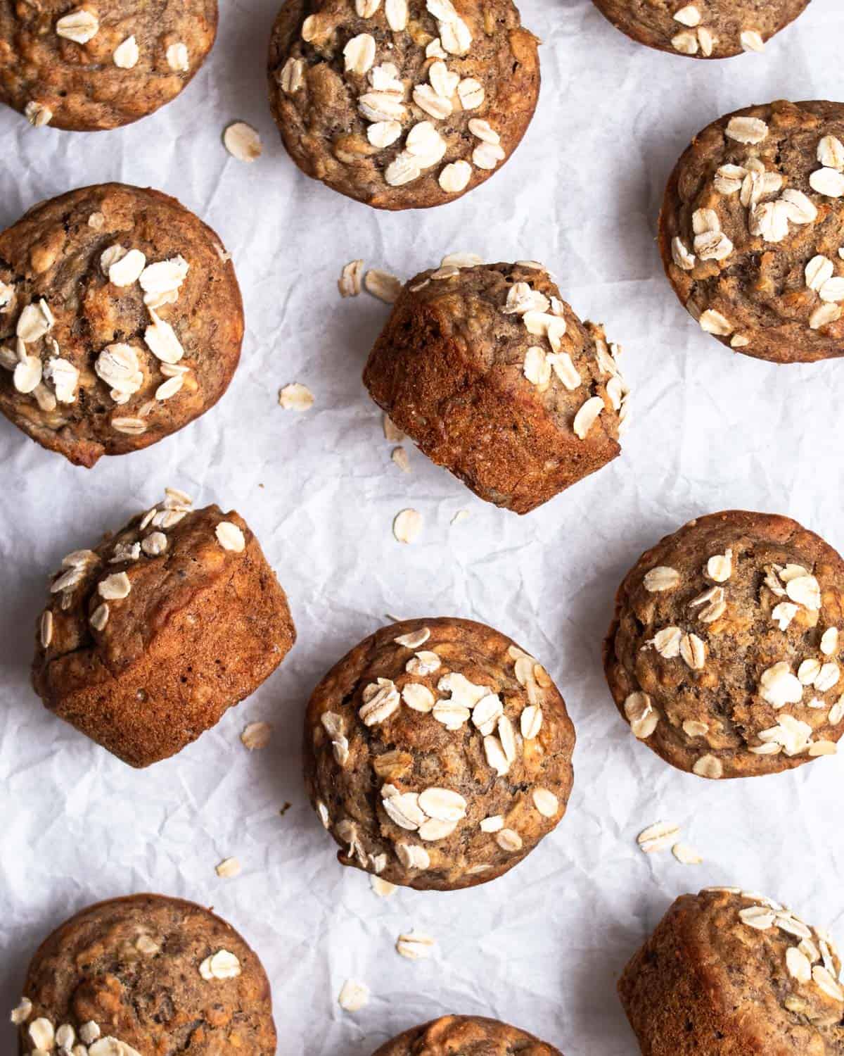 Banana muffins arranged on a parchment paper.