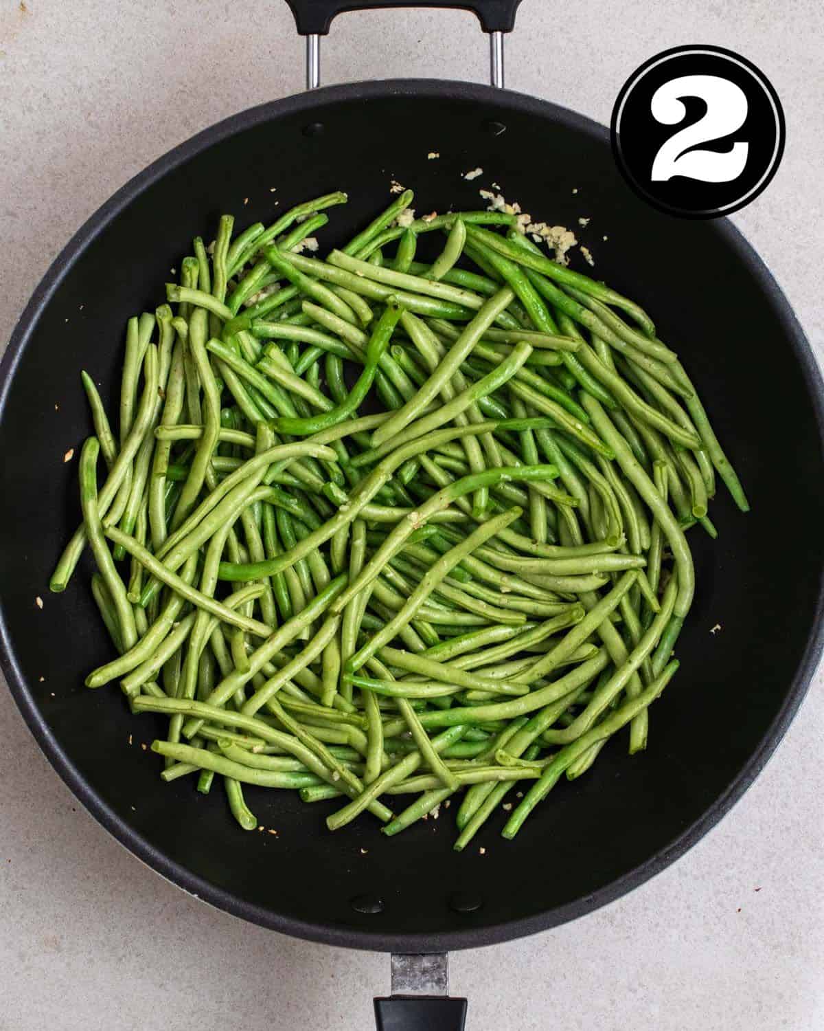 Partially cooked green beans in a wok.