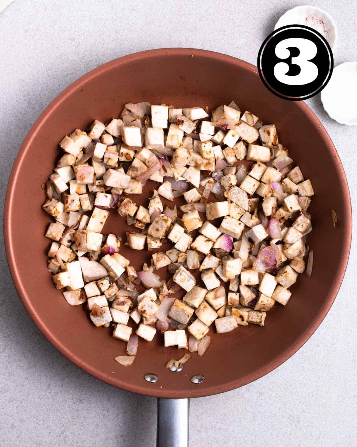 Cooked yam cubes in a non-stick pan.