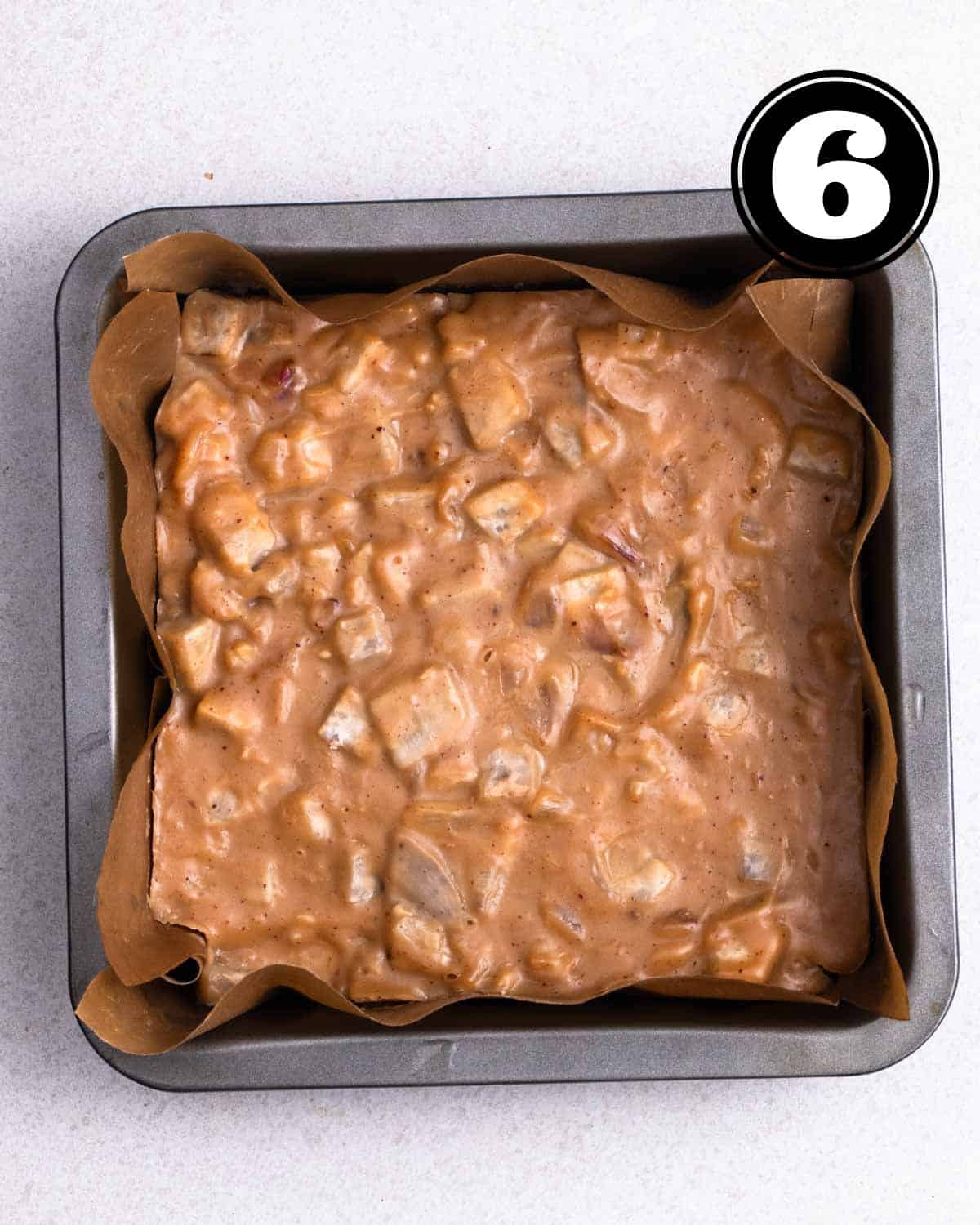 Steamed taro cake in a square pan lined with parchment paper.