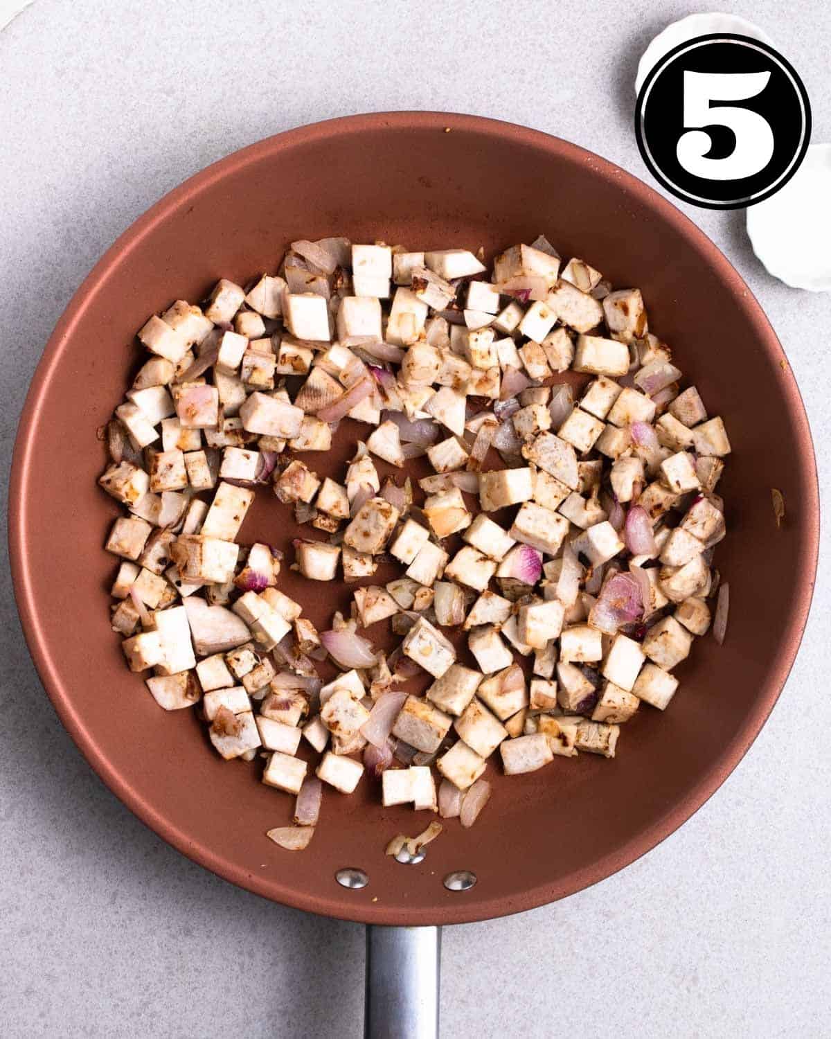 Cooked cubes of taro in a non-stick pan.