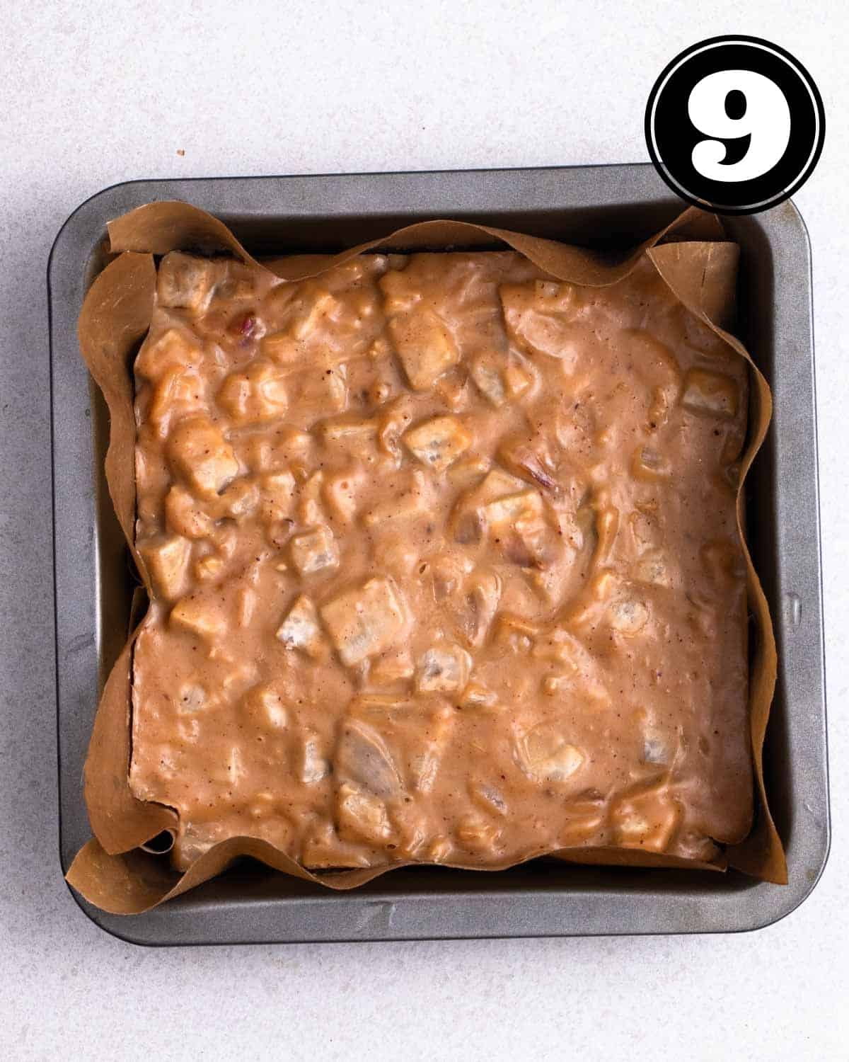 Steamed yam cake in a square baking pan lined with parchment paper.