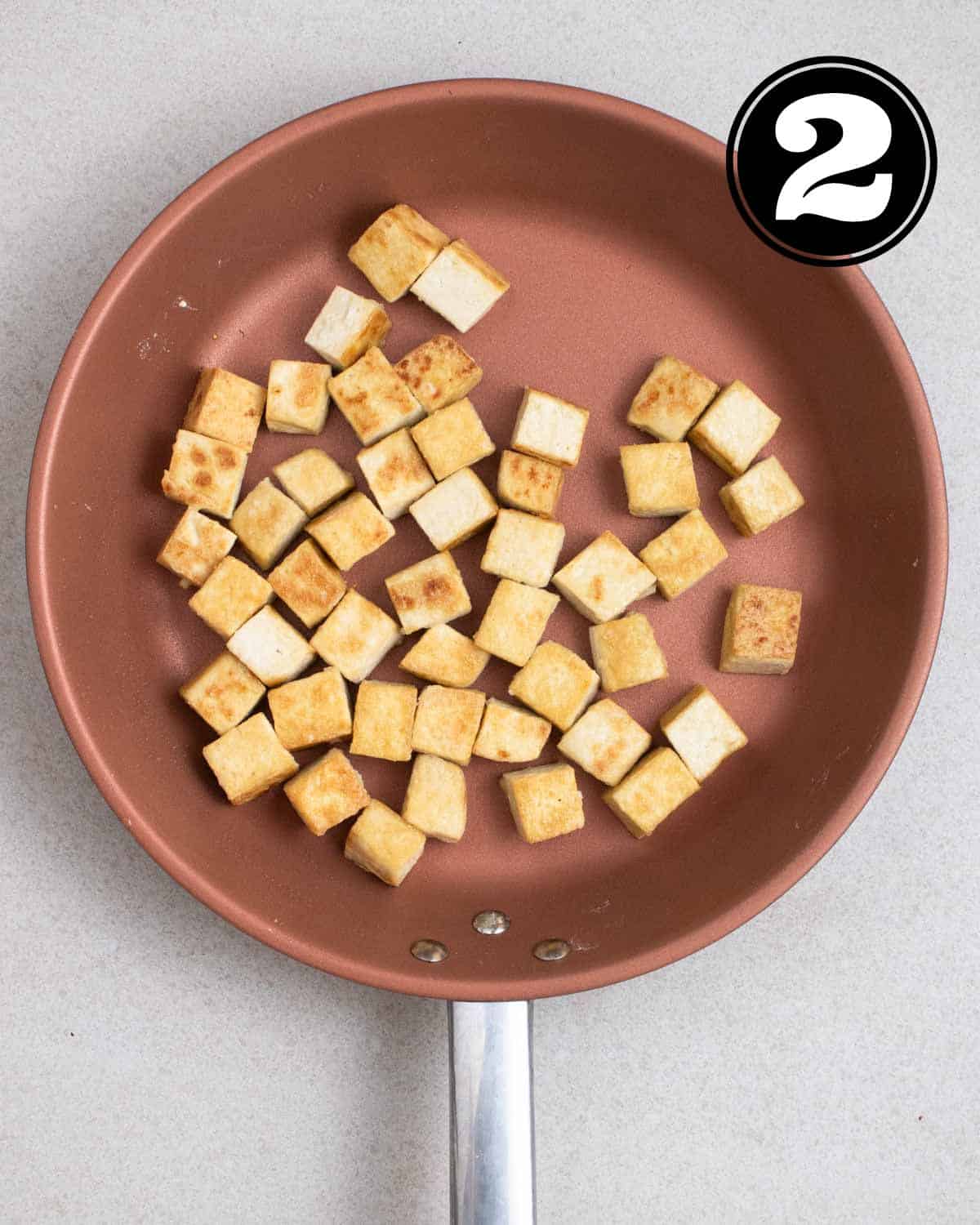 Pan-fried tofu in a non-stick pan.