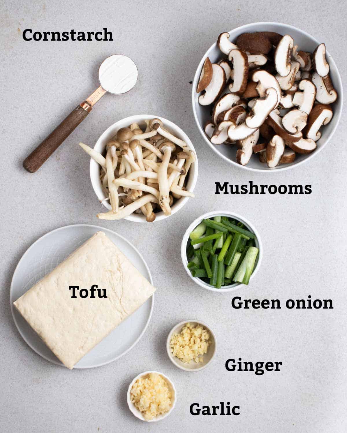 Ingredients needed like mushrooms, cornstarch, green onion, tofu, ginger, and garlic.