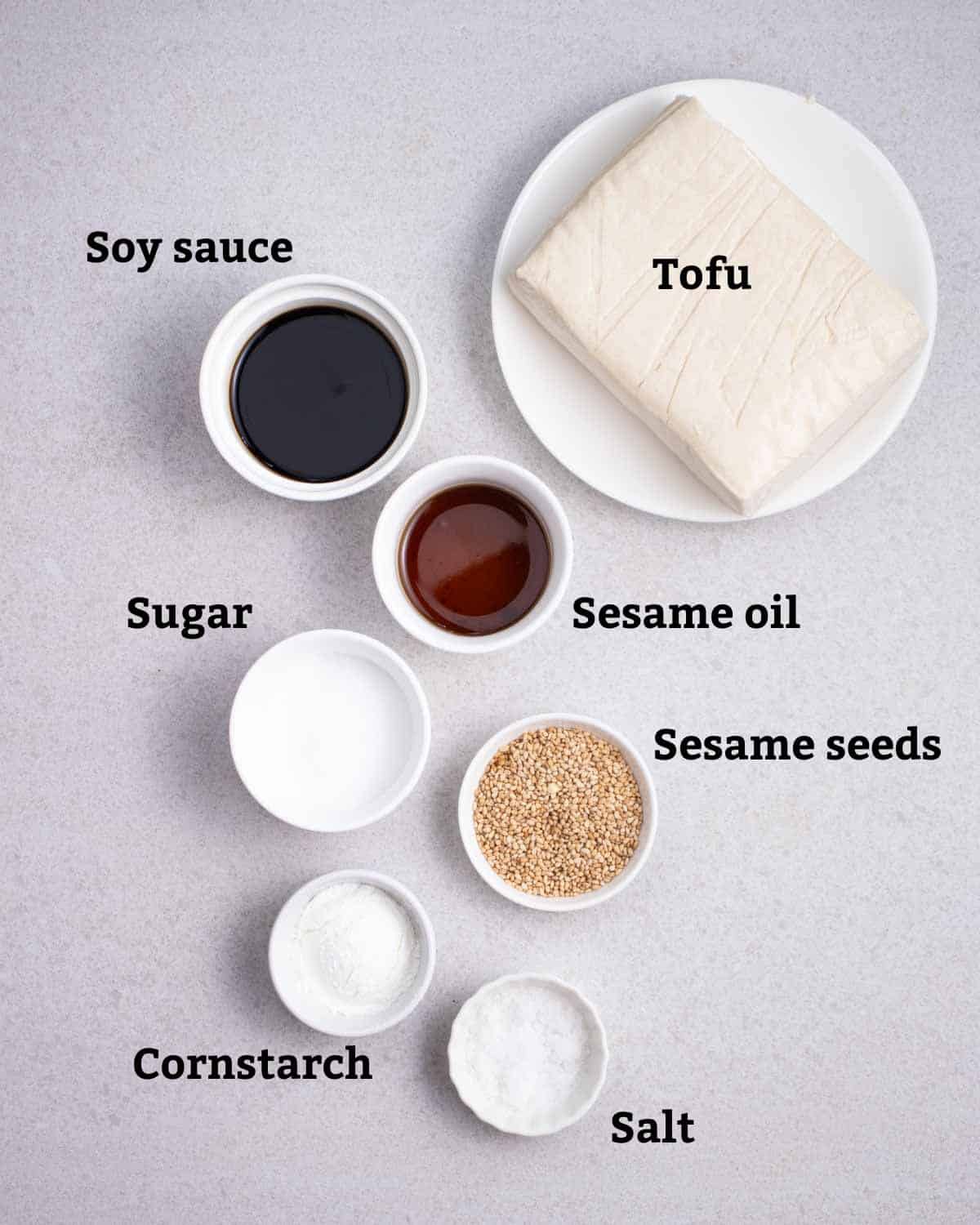 Ingredients needed like tofu, soy sauce, sesame oil, sugar, sesame seeds, cornstarch, and salt.
