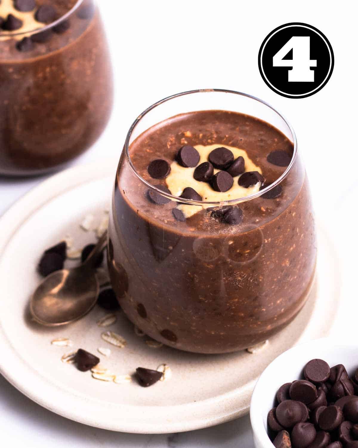 2 jars of overnight oats topped with peanut butter and chocolate chips.