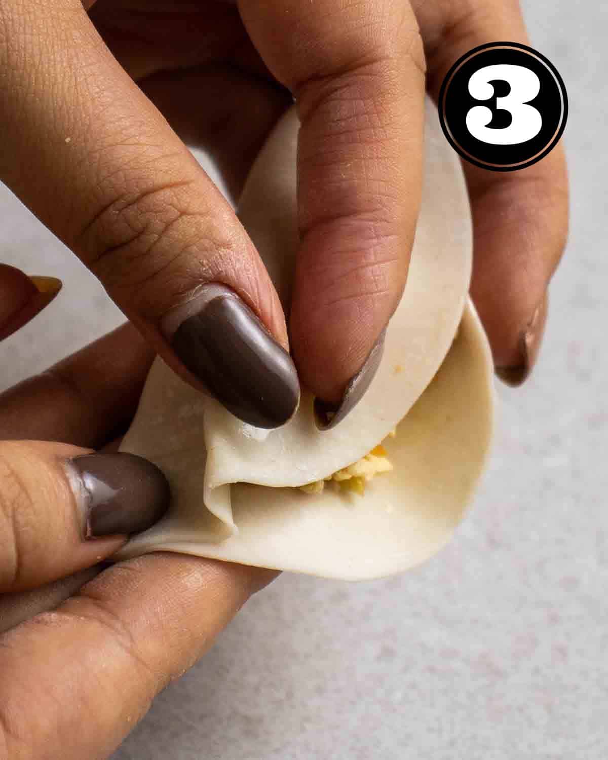 Pleating a dumpling.